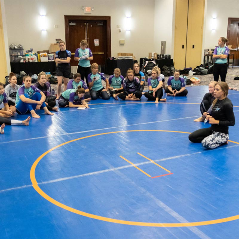 Photo of Nikki Sullivan teaching a seminar at Roll Model Women's Only Grappling Camp